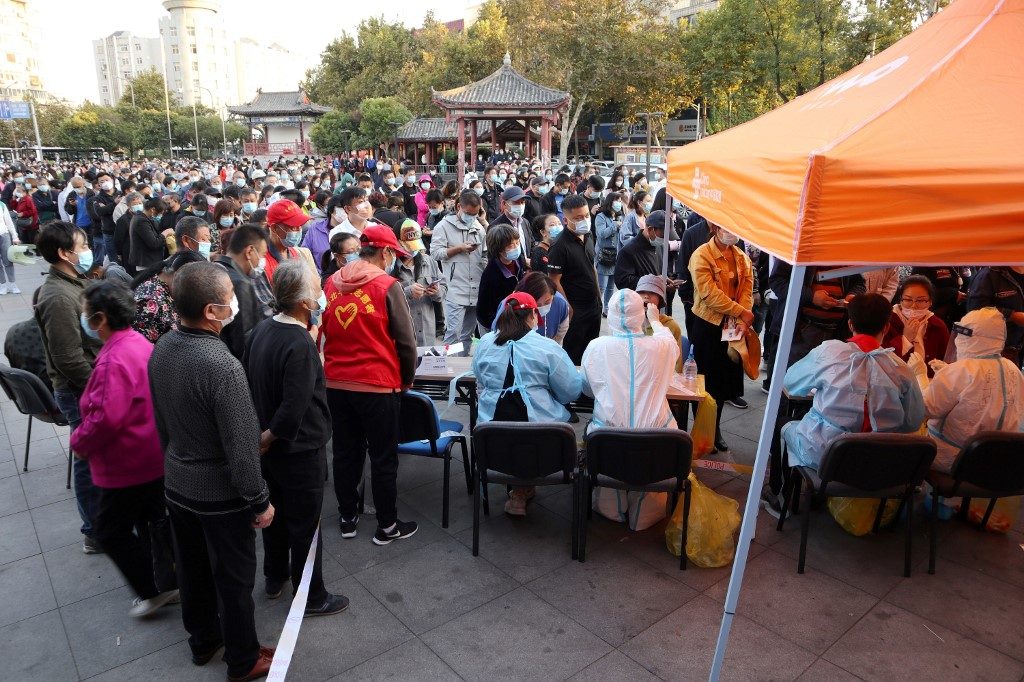 China tests entire city for virus as WHO slams herd immunity idea