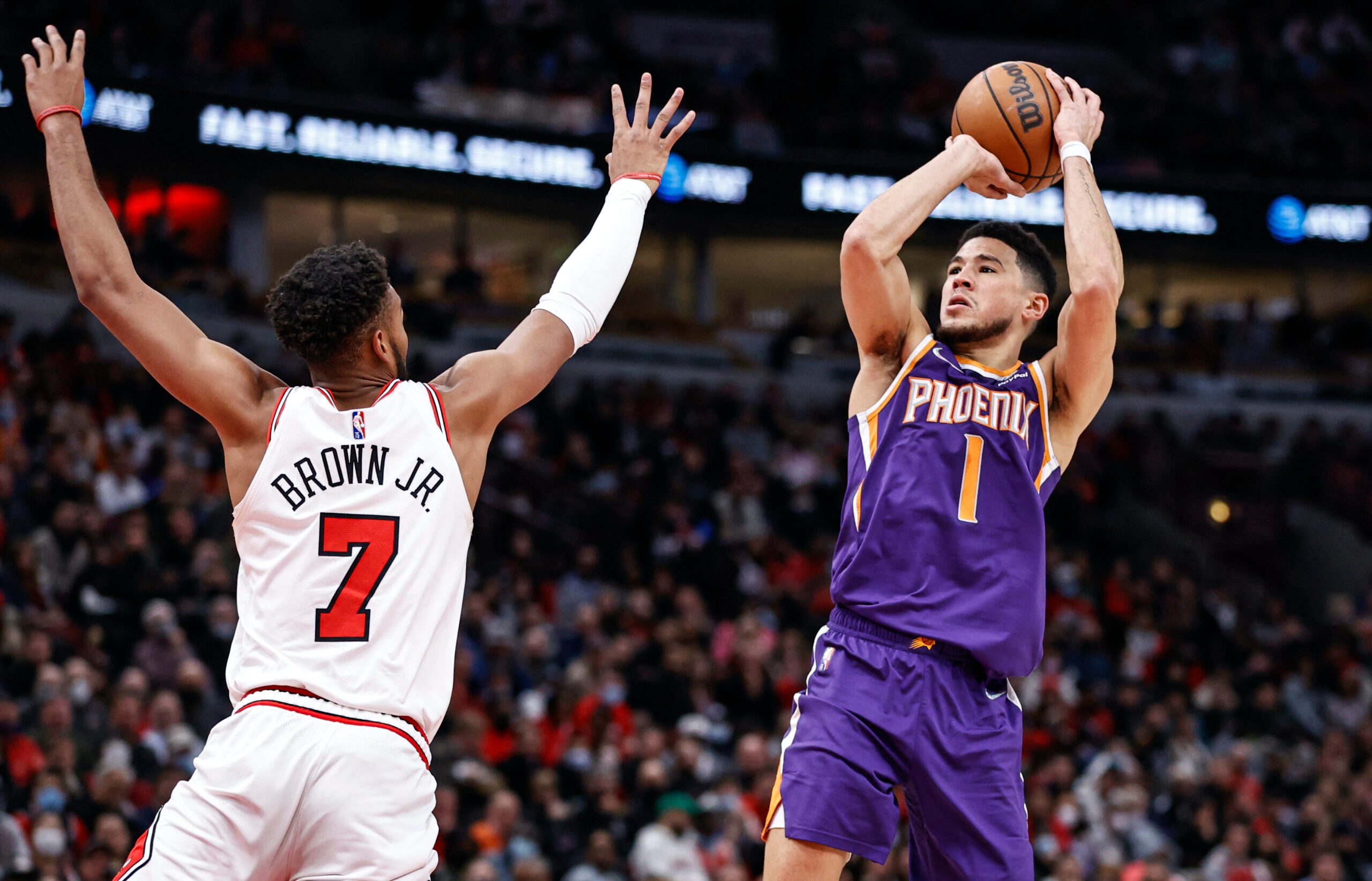 Phoenix Suns' Chris Paul (3) and Devin Booker waits for play to