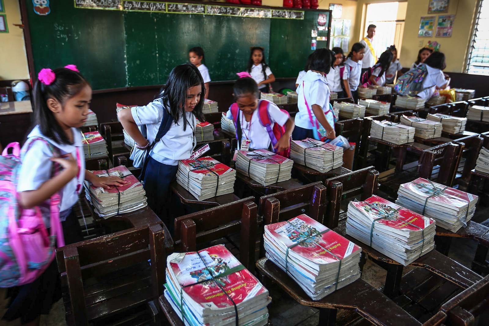 'NEW'. Students of the Corazon Aquino Elementary School in Quezon City receive their books.  
