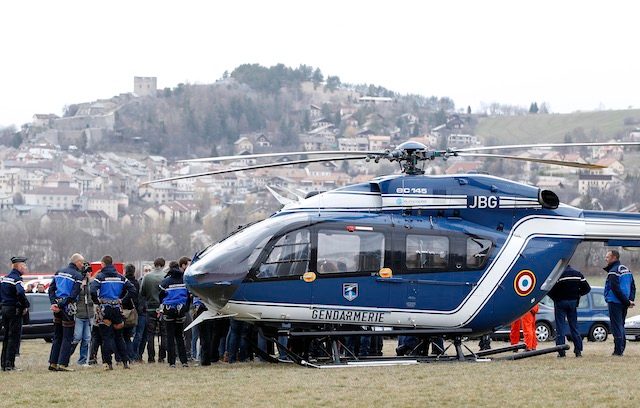 Members of the French Gendarmerie gather close to a helicopter in Seyne les Alpes, southeastern France, 24 March 2015, near the crash site of the Germanwings Airbus A320 in the French Alps. Sebastien Nogier/EPA 