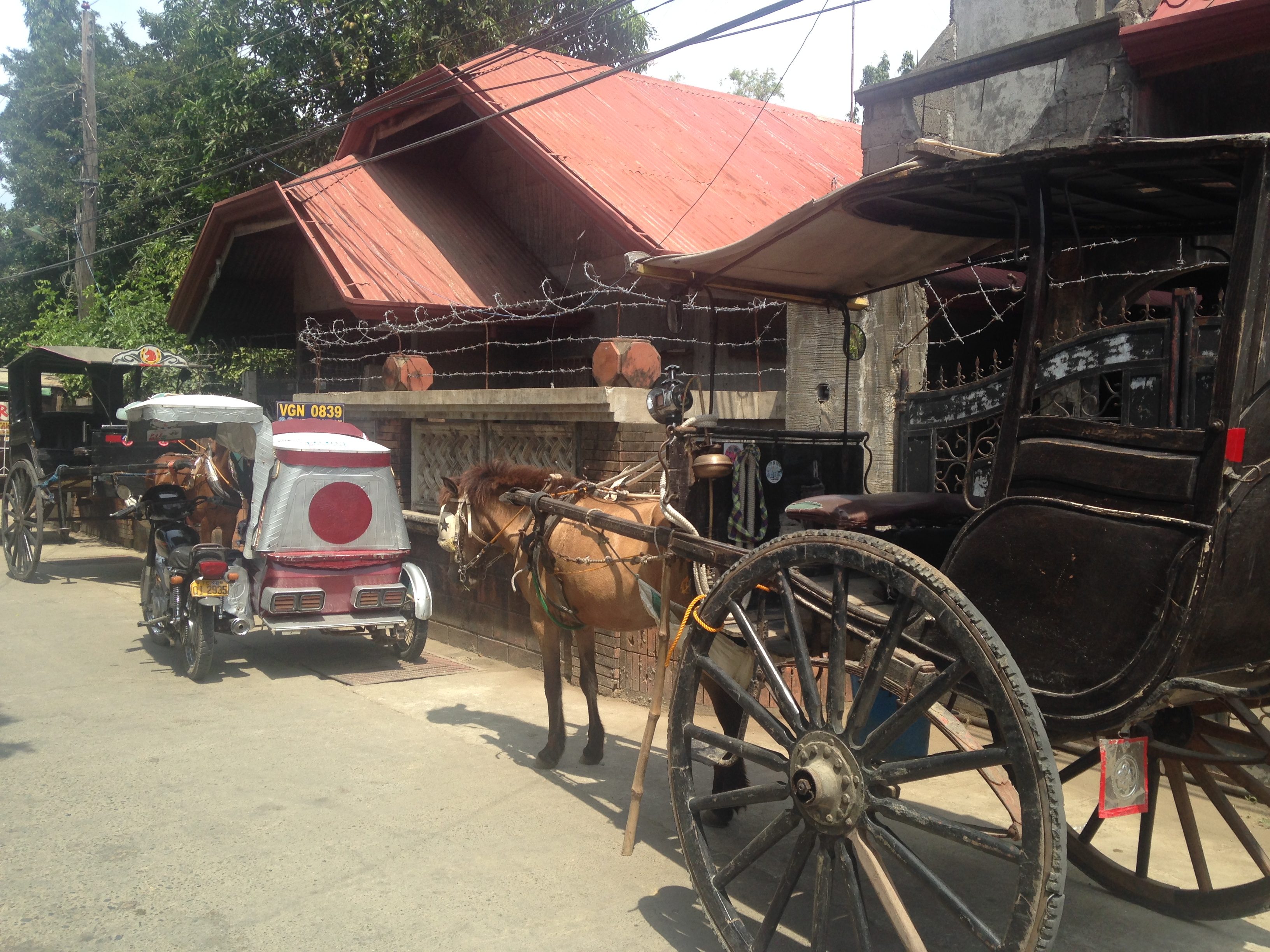 OLD AND NEW. A tricycle and calesa are parked along one of the streets of Vigan. Photo by Jee Y. Geronimo/Rappler  