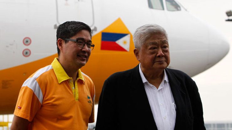 FATHER AND SON. (From left) Lance and John Gokongwei Jr. grace the arrival ceremony of its 2nd Airbus A330-300 aircraft on September 12, 2013. File photo by EPA