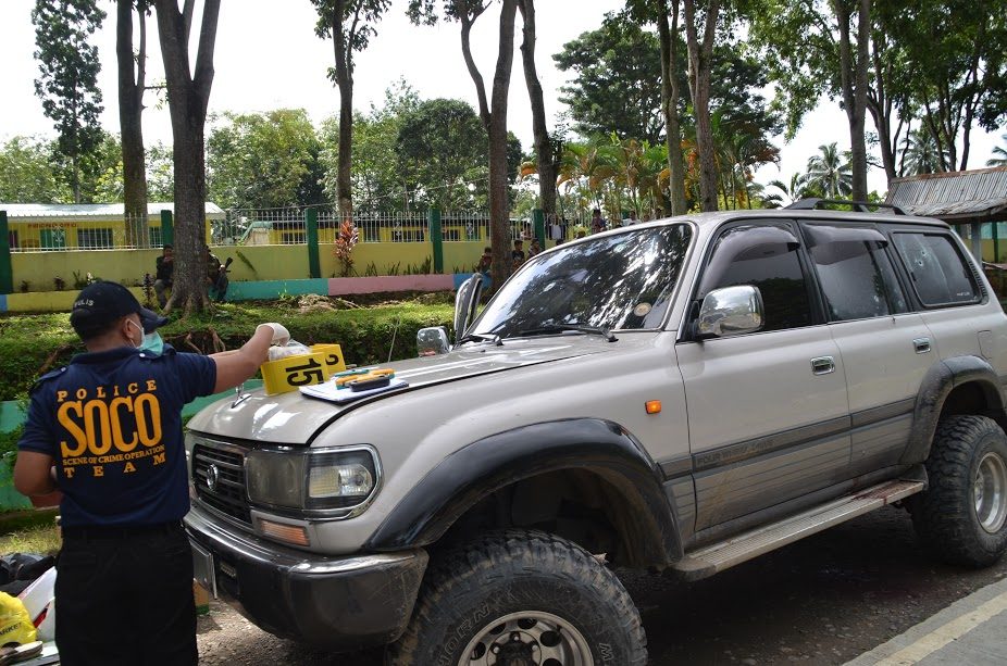 CRIME SCENE. Police crime operatives inspect one of the vehicles on the convoy. Photo courtesy of the office of Mayor Rudy Caoagdan of Makilala 